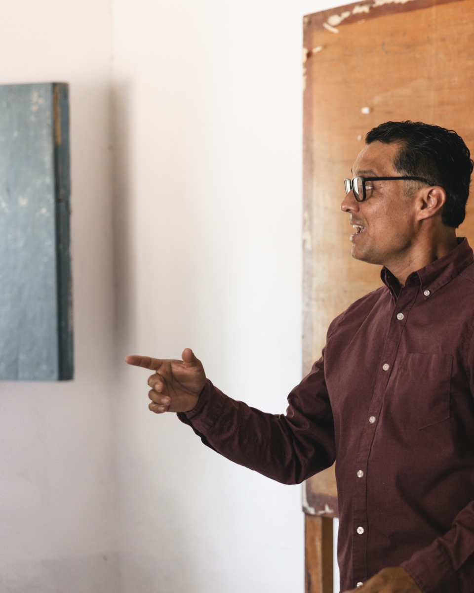 A teacher leading a Bible class, pointing as he explains